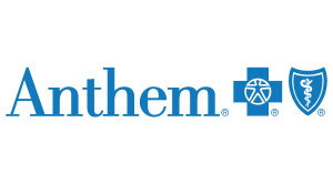 The image displays the logo of  Aetna  with a stylized letter  A  inside a shield, set against a blue background with a white cross symbolizing healthcare services.